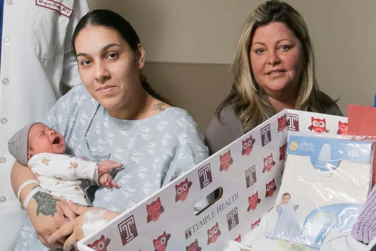 Janessa Hernandez and 3-day-old son Noah LeBr&#0242;n, with nursing director Jennifer Rodriguez, right, next to a box Temple hopes will save infant lives.