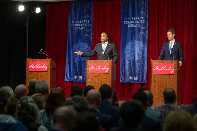 Pennsylvania State Rep. Malcolm Kenyatta, center, points at an empty podium for Lt. Gov. John Fetterman at Sunday's Democratic Senate debate at Muhlenberg College in Allentown. Fetterman skipped the debate, but Kenyatta and U.S. Rep. Conor Lamb, right, made him a starring player nonetheless with their frequent attacks on the Democratic primary front-runner.