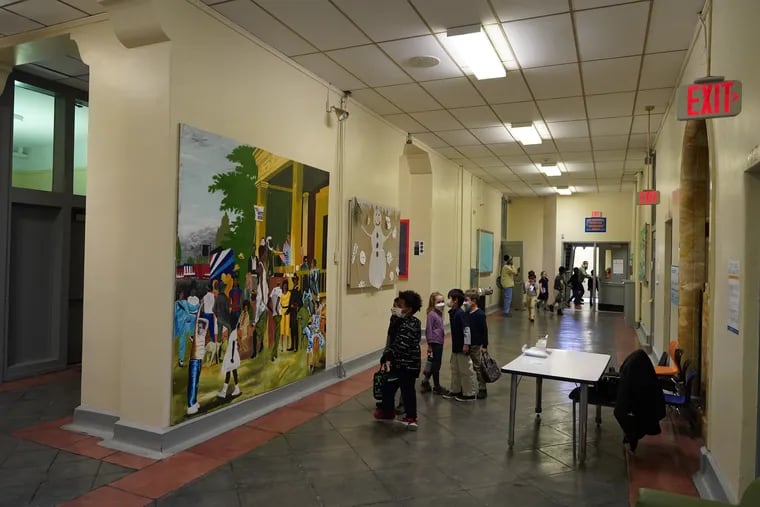Students look at a mural at Lea Elementary in Philadelphia. The school will receive $800,000 a year from the University of Pennsylvania through a new partnership.