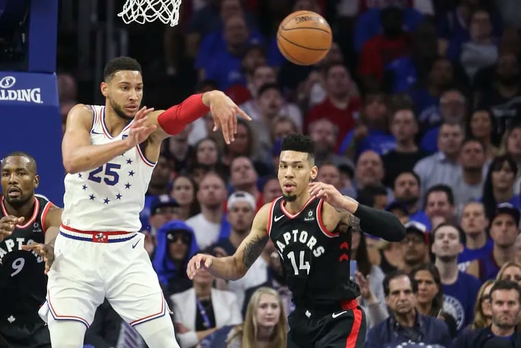 Ben Simmons throws a pass over Raptors' Danny Green during the first quarter Thursday night.