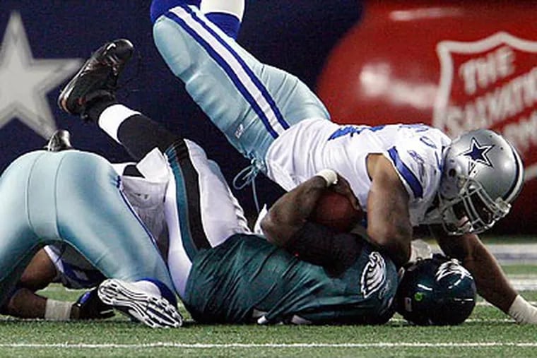 The Cowboys' defense hit Michael Vick hard throughout the game. (Ron Cortes/Staff Photographer)
