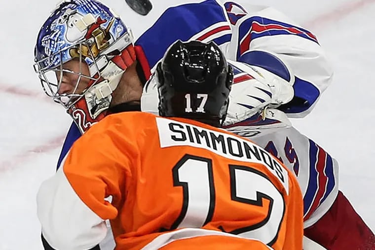 The Flyers' Wayne Simmonds watches the puck sail over the head of Rangers' goalie Antti Raanta during the third period.