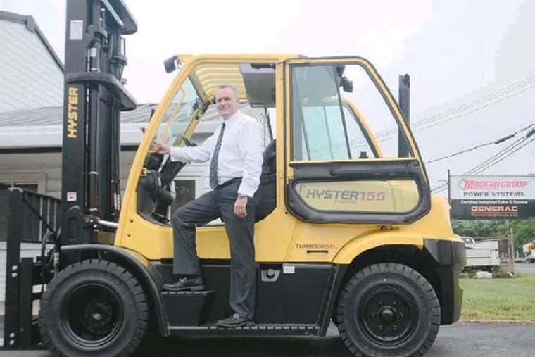 Modern Group CEO Paul Farrell, on a Hyster 155 Fortis Forklift for sale. While forklift sales dropped with the recession, stormy weather helped increase sales of generators and wood chippers. (Viviana Pernot / Staff Photographer)