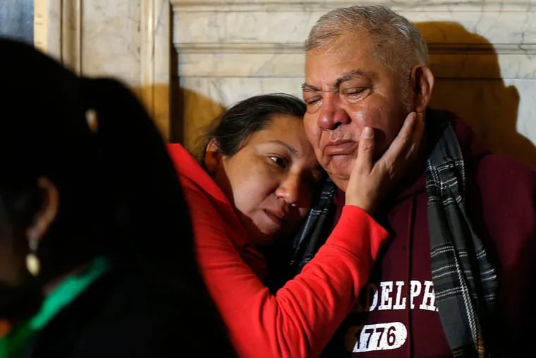 Olivia Ponce comforts her father, Martin, during a news conference in City Hall on Oct. 26, 2016.