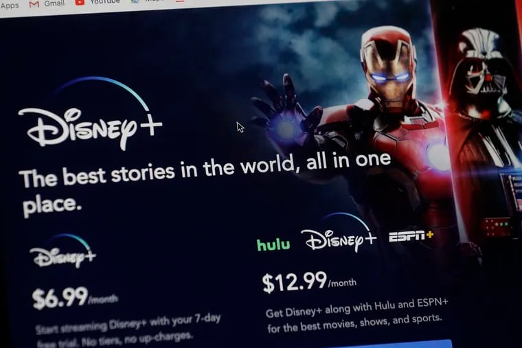 An introductory page on the Disney Plus website is displayed on a computer screen in Walpole, Mass., Wednesday, Nov. 13, 2019. Disney Plus says it hit more than 10 million sign-ups on its first day of launch, far exceeding expectations. (AP Photo/Steven Senne)