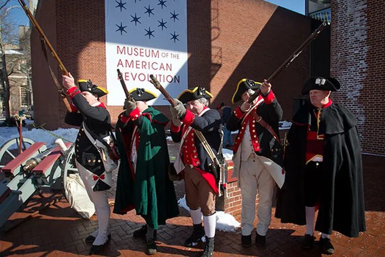 Revolutionary war re-enactors practice their muskett salute before the start of the opening salvo for Museum of the American Revolution at 3rd and Chestnut St. in Philadelphia on Wednesday, March 5, 2014.  ( ALEJANDRO A. ALVAREZ / STAFF PHOTOGRAPHER )