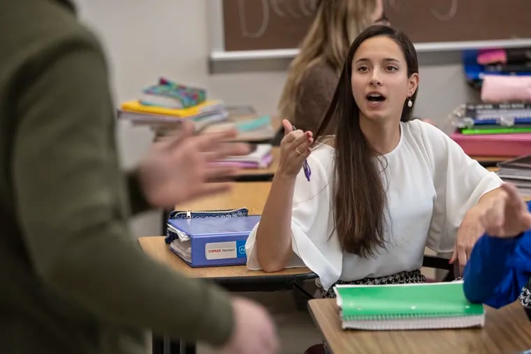 During student discussion time in AP Language class at Dunmore High School, Mia Chiaro, center, senior class president, who will be eligible to vote in the 2020 election, debates the dangers of global warming with Nick Stanco, left, on January 7, 2020.