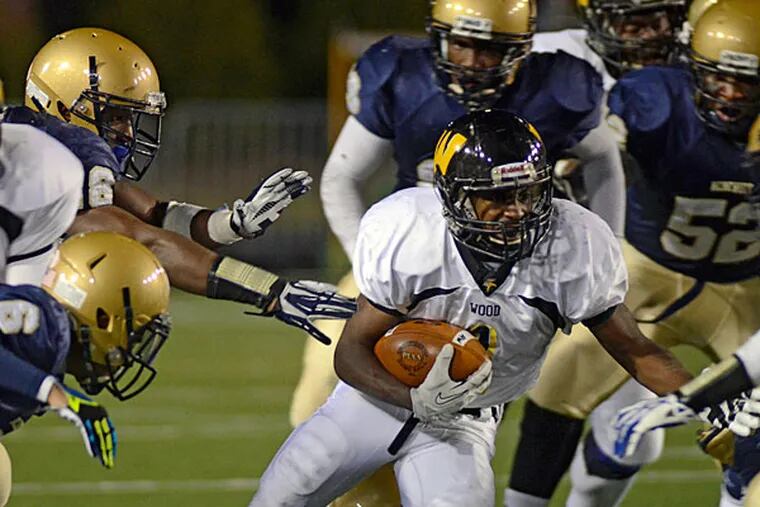 Archbishop Wood's Kendall Singleton (4)  looks for room to pick up
yardage during the first half of a PIAA high school Class AAA
championship football game against Harrisburg's Bishop McDevitt in
Hershey, Pa. on Friday, Dec. 13, 2013. (AP Photo/Ralph Wilson)