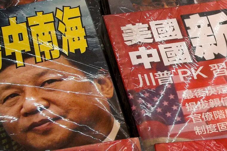 In this July 4, 2019, photo, magazines with front covers featuring Chinese President Xi Jinping with South China Sea and Xi against U.S. President Donald Trump are placed on sale at a roadside bookstand in Hong Kong. The United States said it's concerned by reports of China's interference with oil and gas activities in the disputed waters of the South China Sea, where Vietnam accuses Beijing of violating its sovereignty. (AP Photo/Andy Wong)