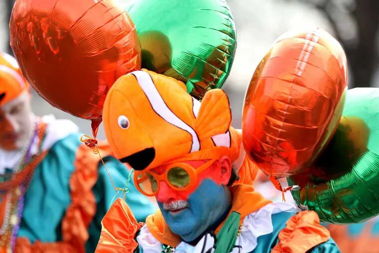 Ed Birzes, of Froggy Carr Wench Brigade, walks up Broad Street with a clown fish hat and balloons attached to his head for their performance of "Frog under the Sea." ( MICHAEL BRYANT / Staff Photographer )