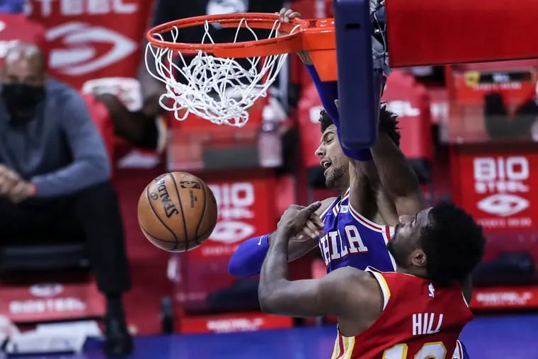 Sixers' Matisse Thybulle dunks over Hawks' Solomon Hill during the 4th quarter at the Wells Fargo Center in Philadelphia, Friday, April 30, 2021. Sixers beat the Hawks 126-104.