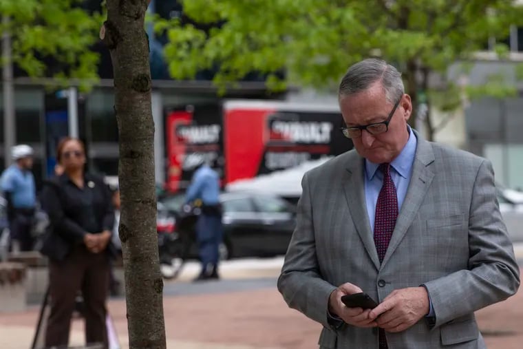 Mayor Jim Kenney texts on his phone during a plaque unveiling ceremony in honor of Edmund Bacon, an urban planner and architect from Philadelphia, is unveiled at LOVE Park on Wednesday, May 08, 2019.