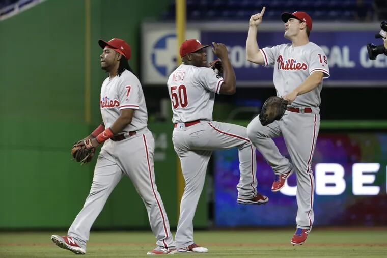 Phillies relief pitcher Hector Neris (50) and first baseman Tommy Joseph, right, celebrate after defeating the Miami Marlins earlier this month.