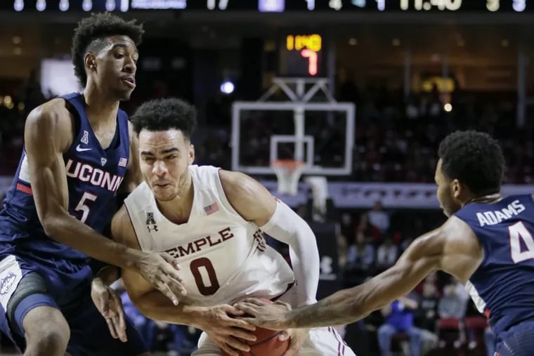 Temple's Obi Enechionyia splitting UConn's Isaiah Whaley and Jalen Adams (4) as he drives to the basket on Jan. 28.