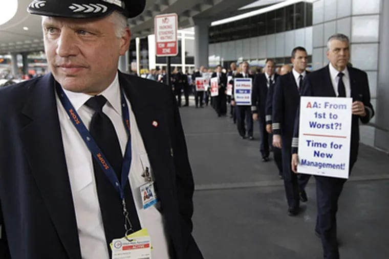 Capt. Mike McClellan (left), with the Allied Pilots Association, picketing with American Airlines pilots at O'Hare in Chicago last month. M. SPENCER GREEN / AP