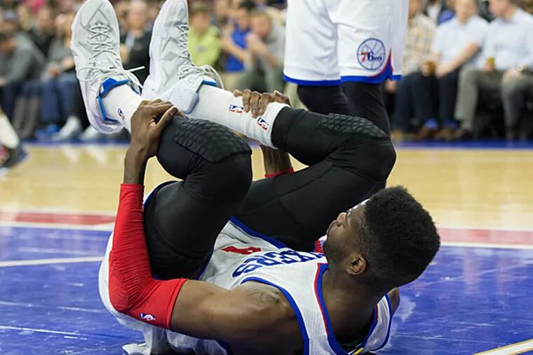 Philadelphia 76ers center Nerlens Noel (4) lays on the floor after falling during the second half against the Washington Wizards at Wells Fargo Center. The Wizards won 119-90. (Bill Streicher/USA Today)