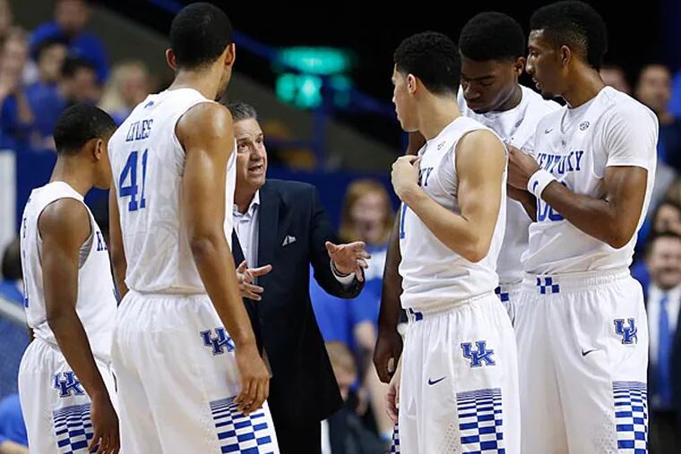Kentucky Wildcats head coach John Calipari talks with his team during a time in the game against the Georgetown Tigers in the first half at Rupp Arena. Kentucky defeated Georgetown 121-52. (Mark Zerof/USA Today)