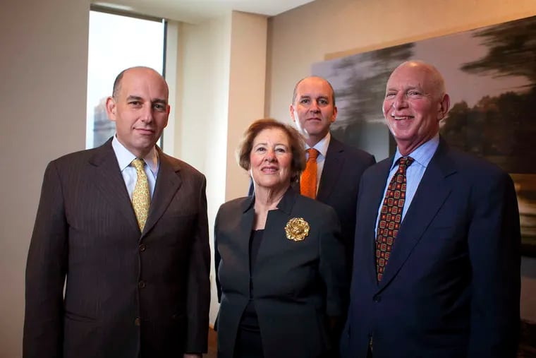 Betsy Zubrow Cohen at center, with sons (from left) Daniel and Jonathan and husband, Edward E. Cohen, in their Rittenhouse Square offices.