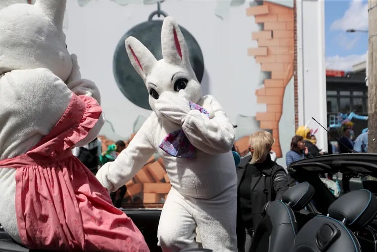Michael Mackin-Wagner, who dressed as Peter Cottontail, climbs into a convertible at the start of the Easter Promenade.