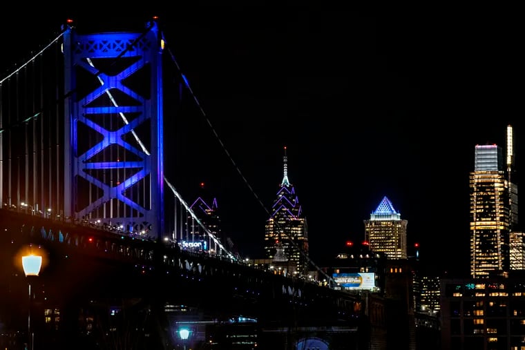 The Ben Franklin Bridge and buildings on the Philadelphia skyline are lighted "Laker Purple" in honor of Kobe Bryant Jan. 27, 2020.