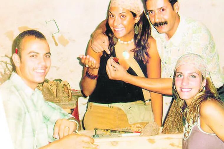 Danielle Andriano (right) and her best friend, Lindsay Wolf, with the wood-carver and one of his sons (left). The women were welcomed into the Moroccans&#0039; home with tea and conversation.