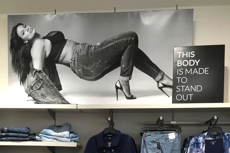A poster inside a Lane Bryant features a message of positivity and a fashionable model. The company has been around since 1904.