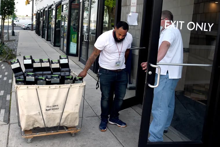 Workers deliver a cart full of ballots from voting machines around the city to the Philadelphia Board of Elections June 4, 2020. On the day after Pennsylvania's primary election, results are taking longer because of a flood of mail-in ballots city officials need to process.