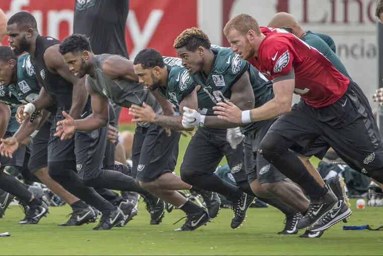 The Eagles offense had to run wind sprints after practice, including quarterback Carson Wentz, #11, right, for committing three false starts during their 11 on 11 drills at Monday’s practice. 08/14/2017 MICHAEL BRYANT / Staff Photographer