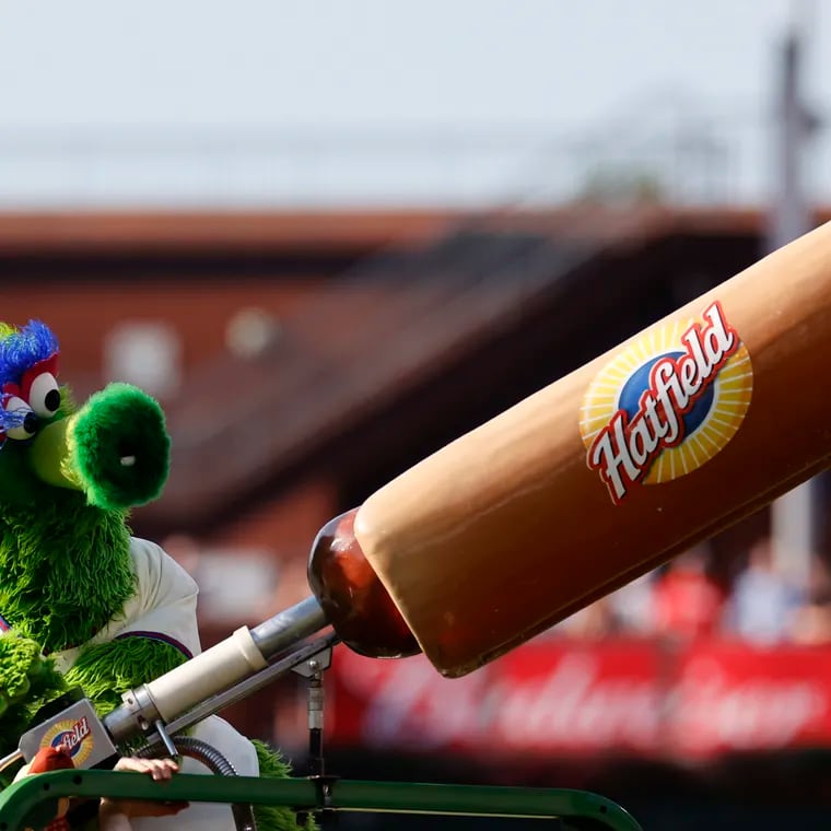 The Phillie Phanatic shoots hot dogs to fans during a break of a Phillies-Giants game in 2022.