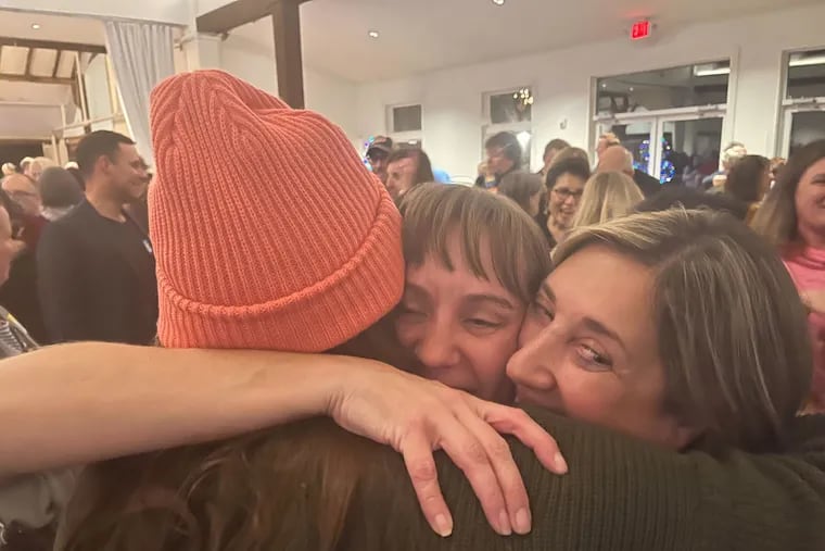 Democrat Susan Gibson, middle, hugs supporters at the Inn at Barley Sheaf Farm in Buckingham Township Tuesday night after an announcement that she and fellow Democrats swept the Central Bucks school board races.