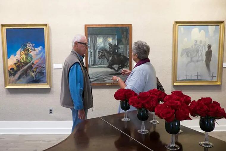 An exhibit of rarely seen paintings by N.C. Wyeth are now on display at the Chester County Art Association for a brief and limited time. Here, Robert Sprague and his wife Russ, of Paoli, view the paintings, including "The Old
Continentals", "Paul Revere's Ride" and "The Unknown Soldier". (ED HILLE / Staff Photographer)