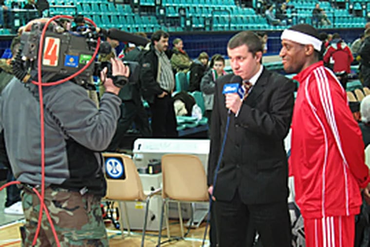 Rashid Atkins interviewed on Polish television before a game. Atkins, who starred at St. Joseph's, plays on a team in Poland with fellow Philadelphian, Dawan Robinson. (Mike Jensen / Inquirer)
