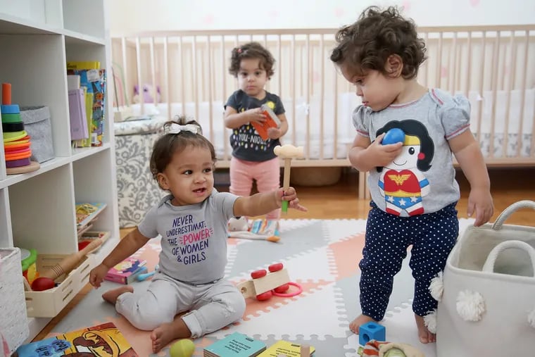 Lennox Abrams (left), 15 months, plays with her friends Arianna Luciano (right), 14 months, and Arianna's twin sister, Giulia, at the twins' home in Philadelphia. Retailers are embracing the theme of female empowerment.