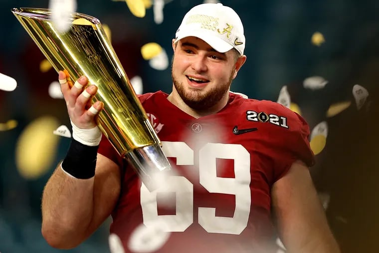 Alabama's Landon Dickerson held the trophy after the Crimson Tide won the College Football Playoff National Championship game in January.