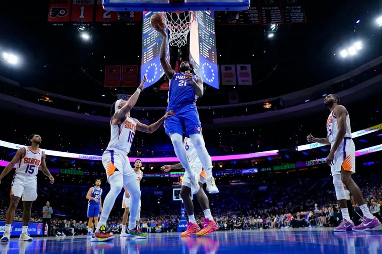 Philadelphia 76ers' Joel Embiid (21) goes up for a shot against Phoenix Suns' Damion Lee (10) during the second half of an NBA basketball game, Monday, Nov. 7, 2022, in Philadelphia.