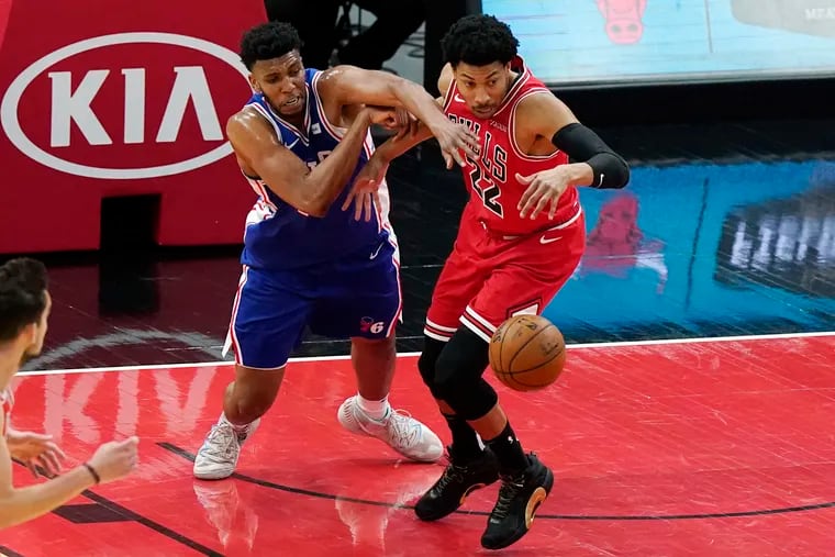 Sixers center Tony Bradley, left, and Chicago Bulls forward Otto Porter Jr., vie for the ball during the first half of Thursday's game.