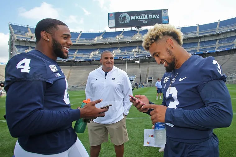 Penn State running backs Ricky Slade (3) and Journey Brown (4) with position coach Ja'Juan Seider during the program's Media Day in August.