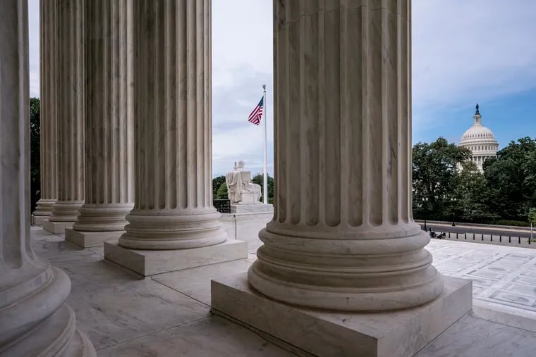 The columns of the Supreme Court with the Capitol at background right in Washington, the day a 6-3 Supreme Court ruling affirmed that gays, lesbians and transgender people are protected from discrimination in employment under the Civil Rights Act of 1964.