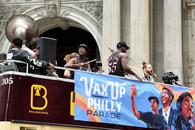 The Snacktime Philly Brass Band perform atop a double-decker bus as they arrive at City Hall Sunday as part of the Vax Up Philly Parade that started earlier in FDR Park, offering free vaccinations, live music, education, free ice cream and more.