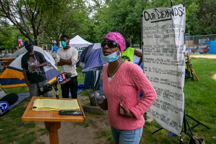 Rashedi Hassan speaks at a news conference at the homeless encampment at 22nd and Ben Franklin Parkway on Wednesday. The organizers have presented a long list of demands to Philadelphia officials. Advocates worry the encampment can spread the coronavirus.