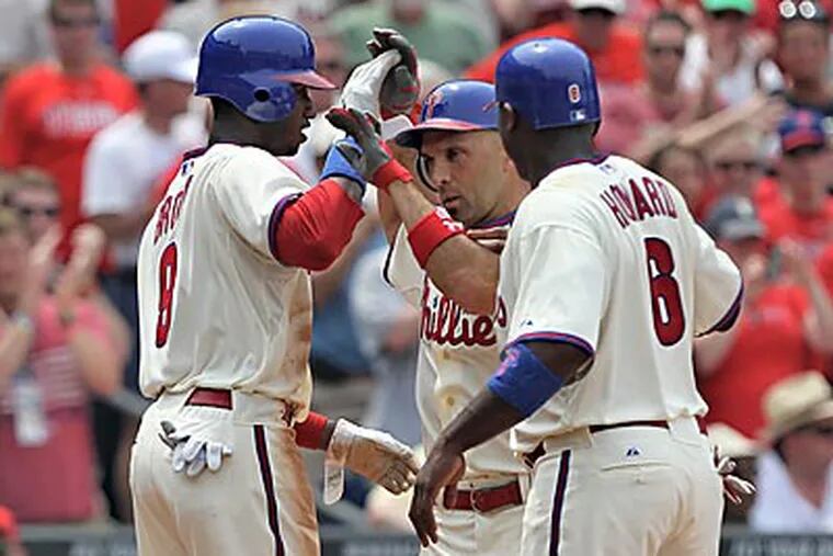 Ryan Howard (left) and Domonic Brown greet Raul Ibanez (center) after Ibanez homered in the third. (David M Warren/Staff Photographer)