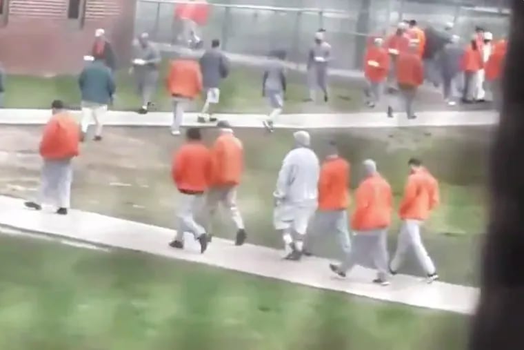 A still from video footage recorded by an inmate with a smuggled cellphone at the federal prison in Fort Dix, N.J. , shows prisoners in the yard, where recommended social distancing guidelines don't appear to be followed. The video was posted to Twitter earlier this year.