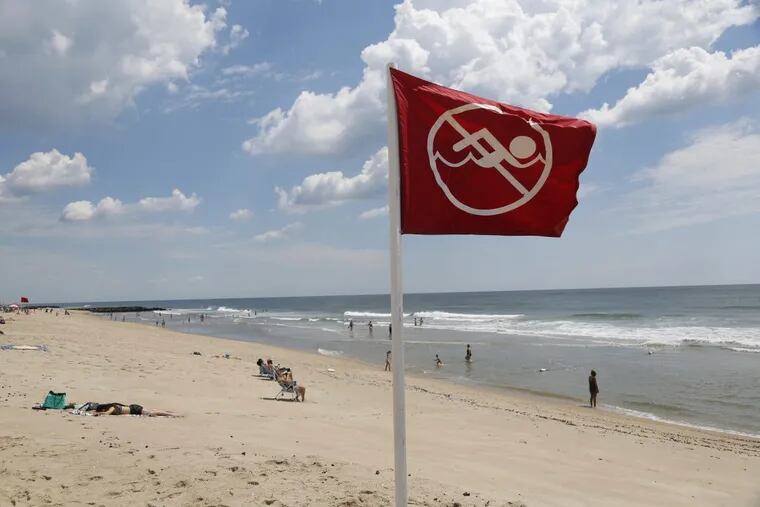 A &quot;no swimming&quot; sign is seen in Asbury Park, N.J.
