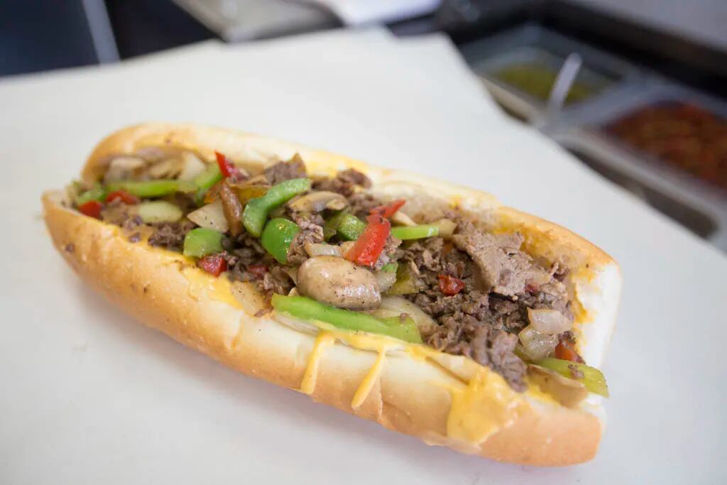 A Sumo Steaks cheesesteak with onions, mushrooms, peppers and whiz cheese. ( Colin Kerrigan / Philly.com )
