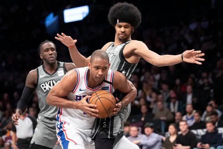 76ers center Al Horford drives to the basket in front of Brooklyn Nets center Jarrett Allen.