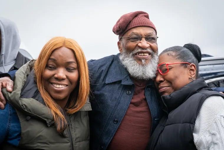 William Franklin, center, embraces his daughters Rasheedah Franklin, left, and Gina Gibson after his release from prison. He served 44 years.