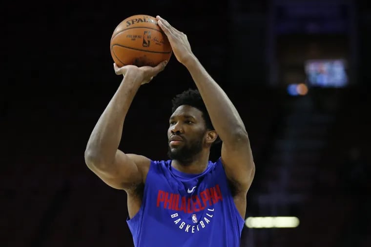 Sixers center Joel Embiid shoots the basketball while warming-up before the Sixers play the Toronto Raptors on Thursday.