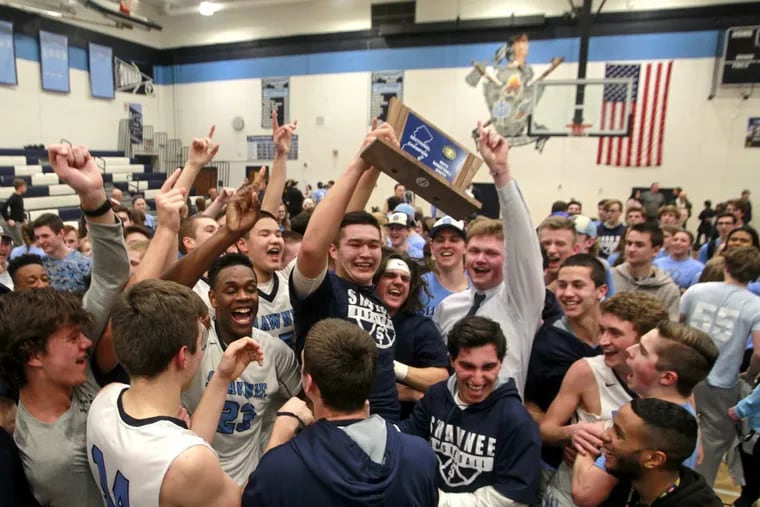 The Shawnee boys’ basketball team celebrates winning South Jersey Group 4 title.
