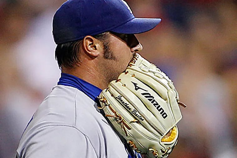 Jonathan Broxton  wipes his face after walking Phillies' Mike Sweeney in the ninth inning. (AP Photo/Matt Slocum)