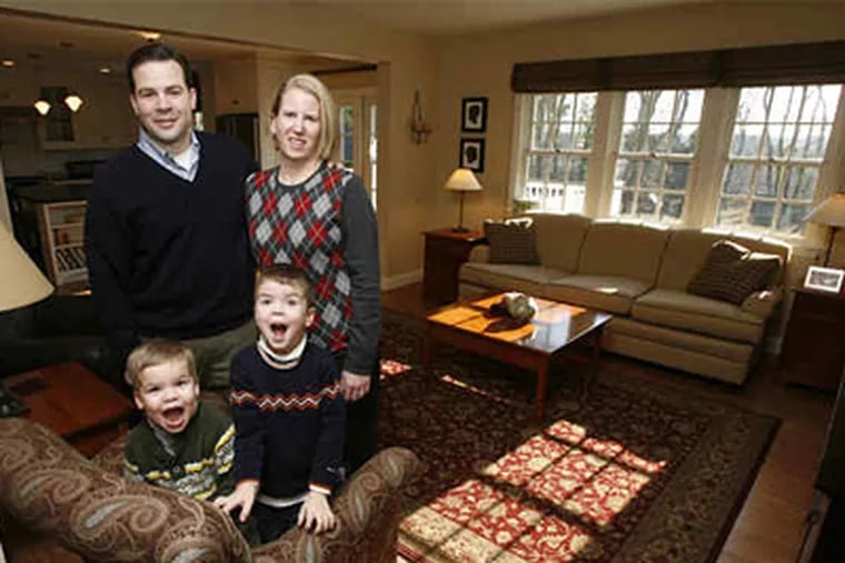 The Maggittis - Pat, Sara, and sons Sean (left) and Patrick - in the family room of their St. Davids home. "We paid attention to how we live our lives and made a space that fits that," Sara Maggitti said. (Charles Fox / Staff Photographer)
